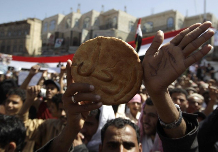 A protester holds a piece of bread with the word &quot;Leave!&quot; on it during an anti-government rally outside Sanaa University
