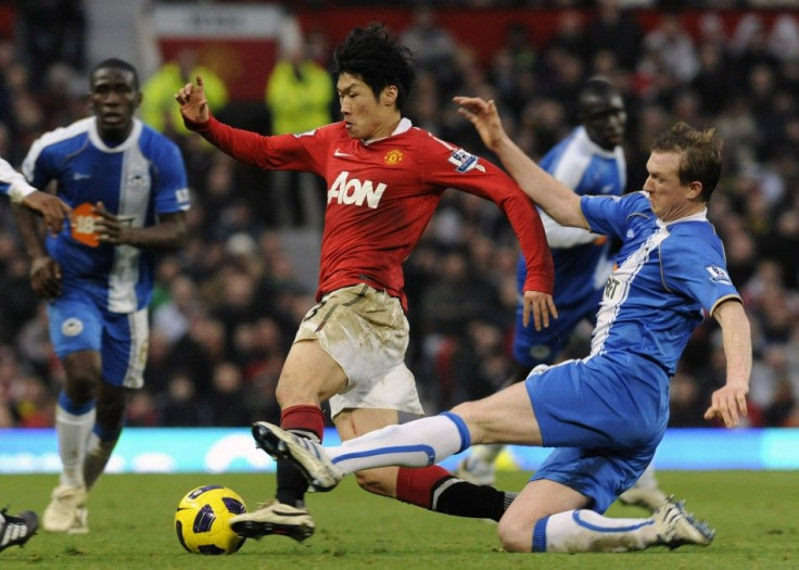 Wigan Athletic's Steven Caldwell (R) challenges Manchester United's Park Ji-sung during their English Premier League soccer match in Manchester.