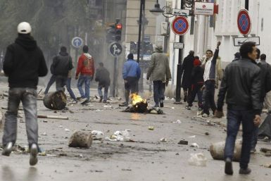 Anti-government protesters clash with riot police in downtown in Tunis 