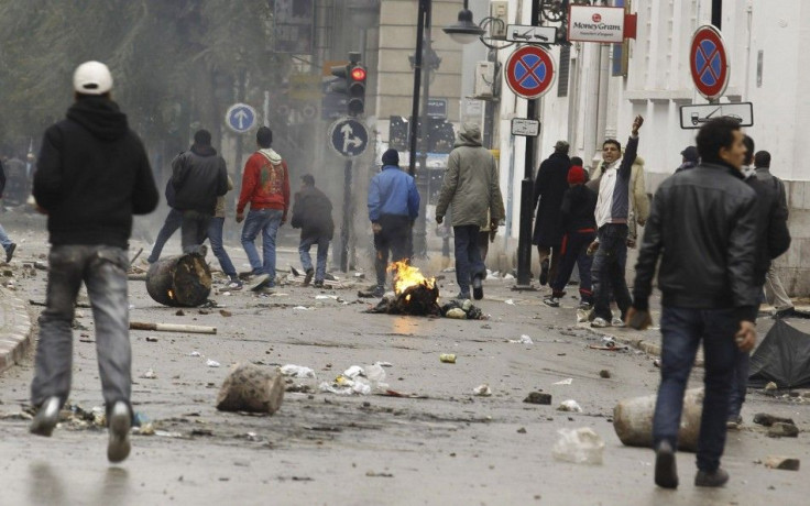 Anti-government protesters clash with riot police in downtown in Tunis