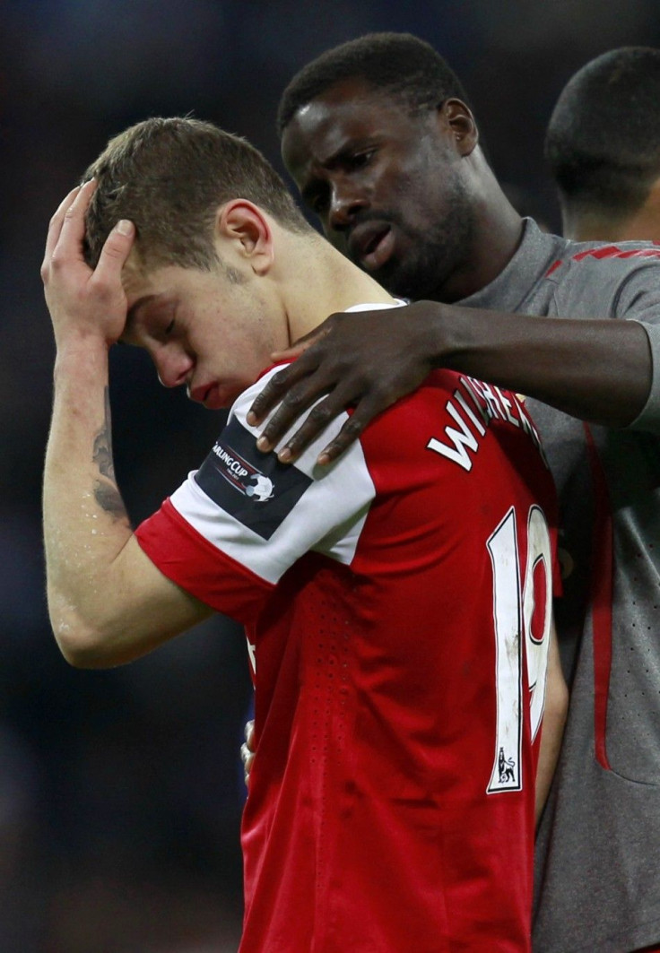 Arsenal's Wilshere is consoled by team-mate Eboue after losing to Birmingham City during their English League Cup final soccer match at Wembley Stadium in London.