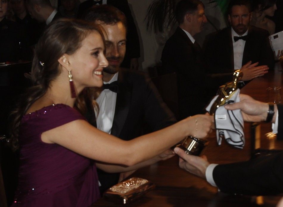 Actress Natalie Portman holds her Oscar she won for best actress for her role in quotBlack Swanquot after the name plate was engraved at Governors Ball in Hollywood