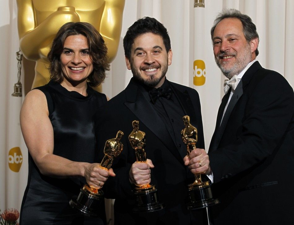 Oscar winners for music sound mixing for the film Inception, Lora Hirschberg, Gary A. Rizzo C, and Ed Novick, pose backstage at the 83rd Academy Awards in Hollywood, California.