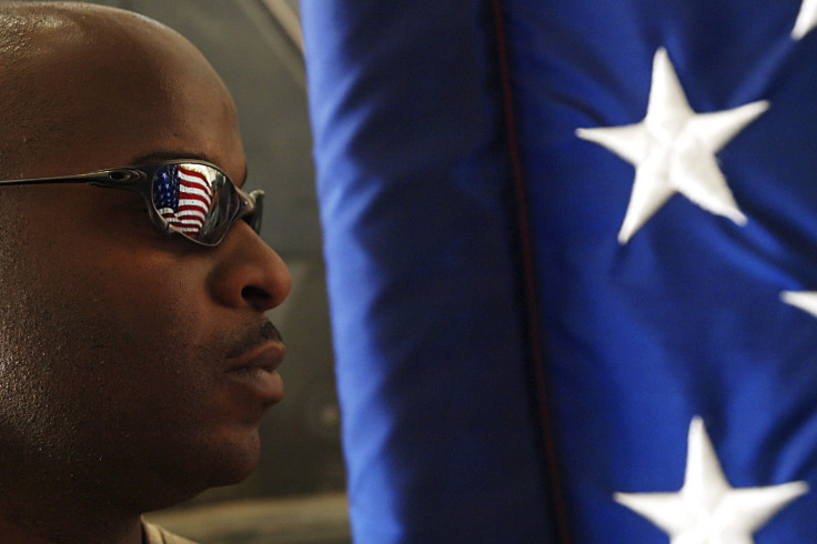 An African-American Soldier Stands Beside The U.S. Flag