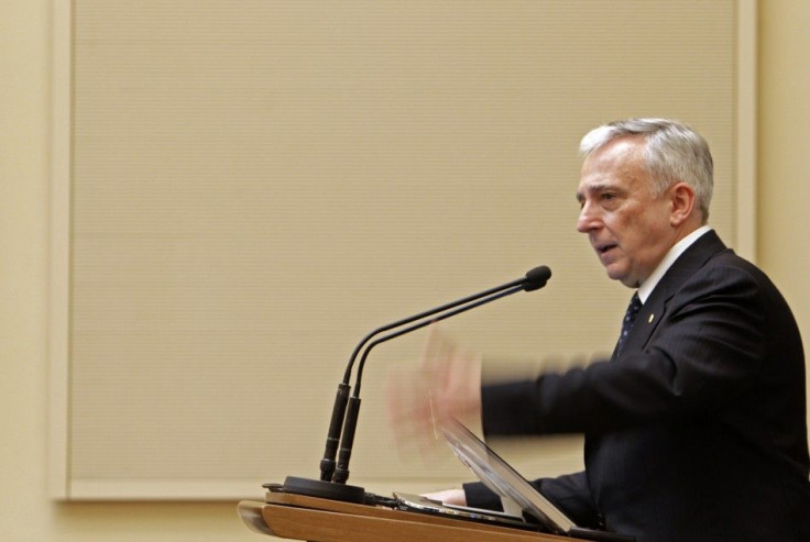 Romania's central bank governor Isarescu gestures during a news conference in Bucharest