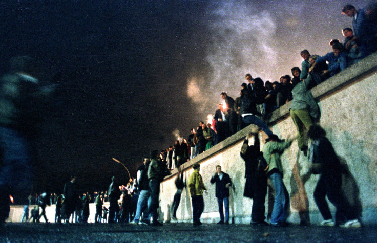 East German Citizens Clamber Over The Berlin Wall