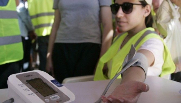 Education linked to lower blood pressure. A woman has her blood pressure taken at a World Hypertension Day event 