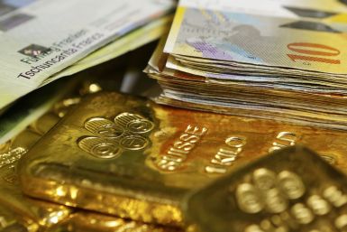 swiss franc banknotes and gold bars