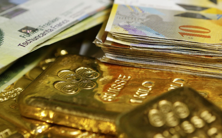 swiss franc banknotes and gold bars