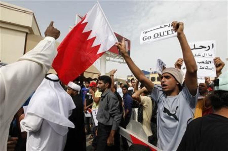 Bahraini Shi'ite men shout anti-government slogans as they protest outside the parliament in Bahraini capital of Manama