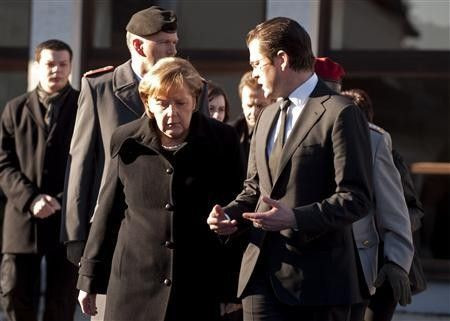 German Chancellor Angela Merkel and Defence Minister Karl-Theodor zu Guttenberg