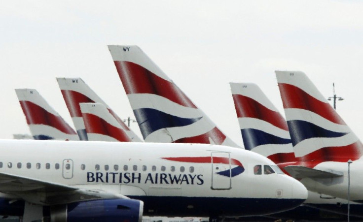 A British Airways passenger jet taxis past parked BA jets at Heathrow airport in London
