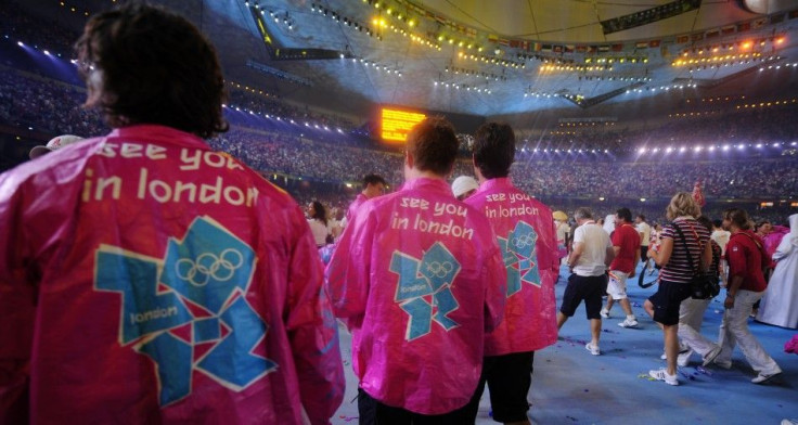 Participants wear shirts with the logo of the London 2012 Olympics during the closing ceremony of the Beijing 2008 Olympic Games at the National Stadium