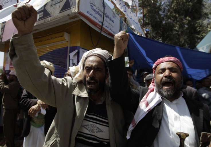 Anti-government protesters shout slogans during a protest demanding the ouster of Yemen's President Ali Abdullah Saleh outside Sanaa