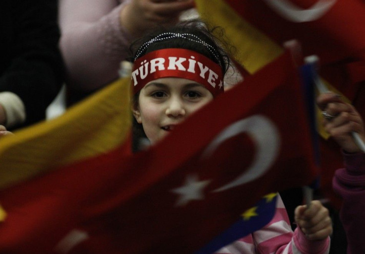 A Turkish girl waves a German and a Turkish flag during the arrival of Turkish Prime Minister Tayyip Erdogan in Duesseldorf