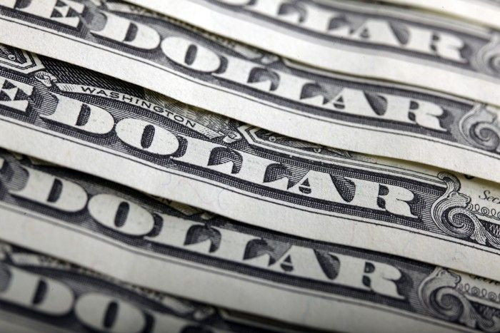 A picture illustration shows U.S. dollar bank notes