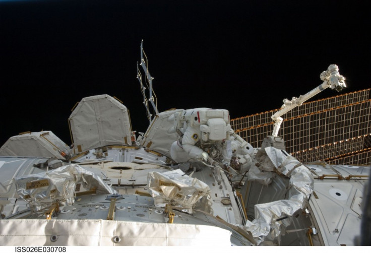 STS-133 Mission Specialists Steve Bowen (foreground) and Alvin Drew participate in the mission's first spacewalk as construction and maintenance continue on the International Space Station. 