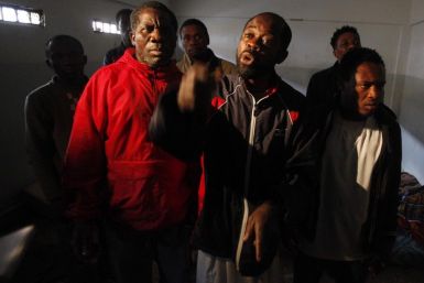 Suspected African mercenaries held by anti-government protesters stand in a room at a courthouse in Benghazi