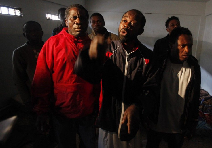Suspected African mercenaries held by anti-government protesters stand in a room at a courthouse in Benghazi
