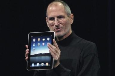 Apple CEO Steve Jobs holds tan iPad during the launch of Apple&#039;s new tablet computing device in San Francisco