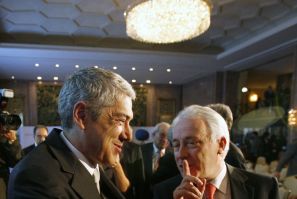 Portugal's Prime Minister Jose Socrates (L) speaks with Portugal Central Bank Governor Carlos Costa during a conference organized by Reuters and TSF radio in Lisbon February 28, 2011.
