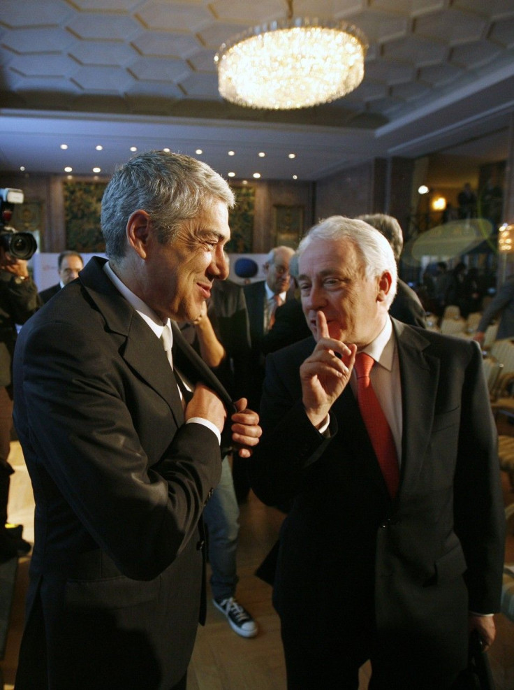 Portugal's Prime Minister Jose Socrates (L) speaks with Portugal Central Bank Governor Carlos Costa during a conference organized by Reuters and TSF radio in Lisbon February 28, 2011.