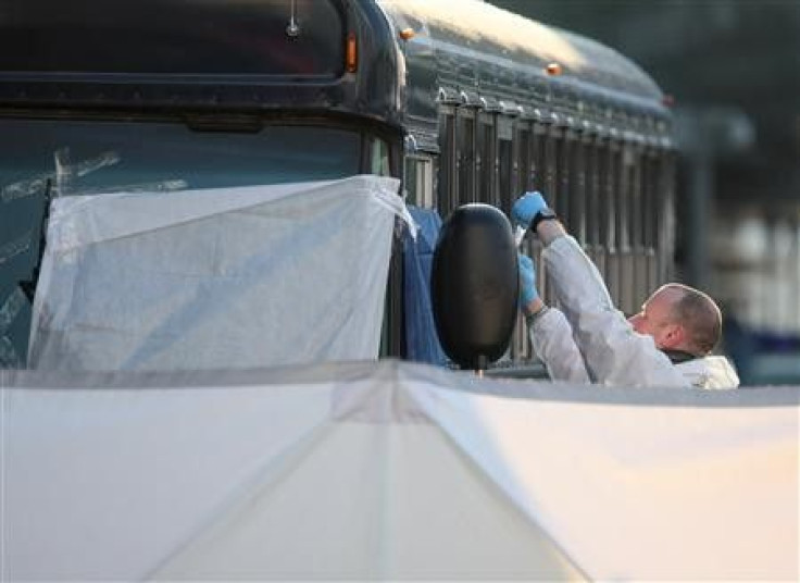 A forensic expert examines an U.S. Army bus in front of Frankfurt airport