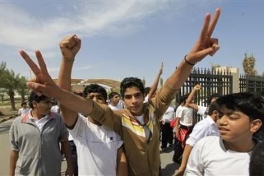 High school students gesture, during a protest to demand the resignation of the education minister
