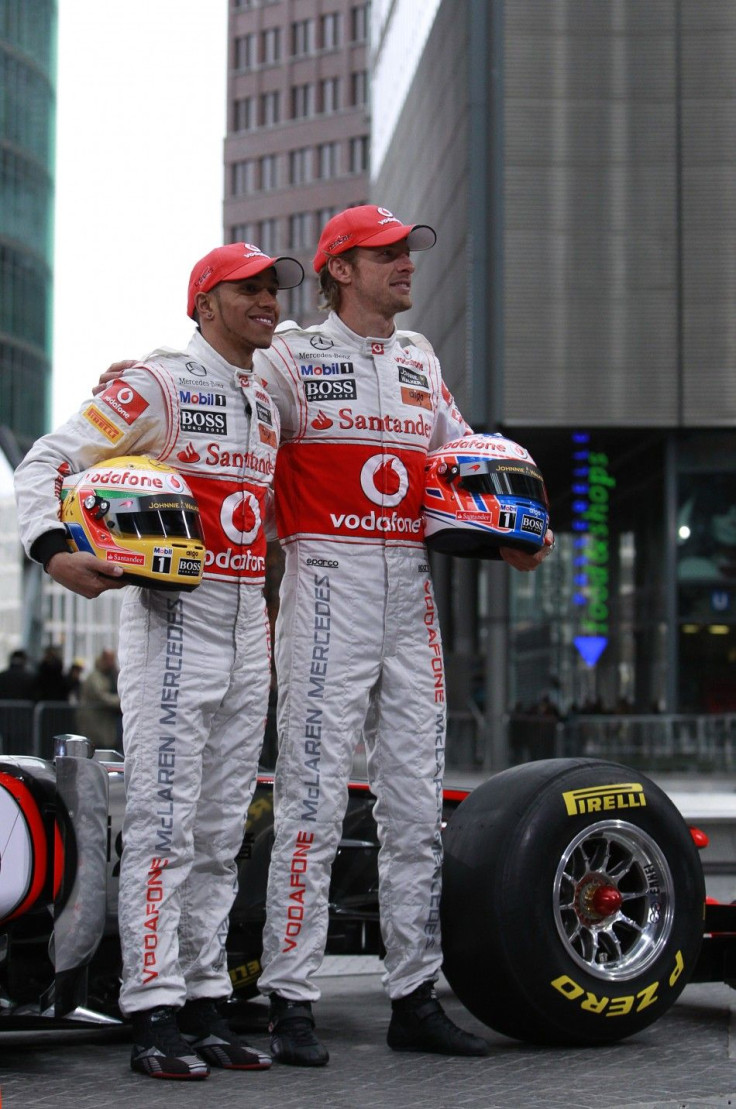 McLaren Formula One racing drivers Hamilton and Button of Britain pose for pictures during revealing of McLaren Mercedes MP4-26 racing car in Berlin.