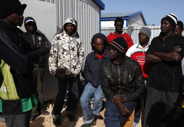 African migrant workers stranded in Libya gather to talk at a refugee camp set up by a Turkish company in Benghazi