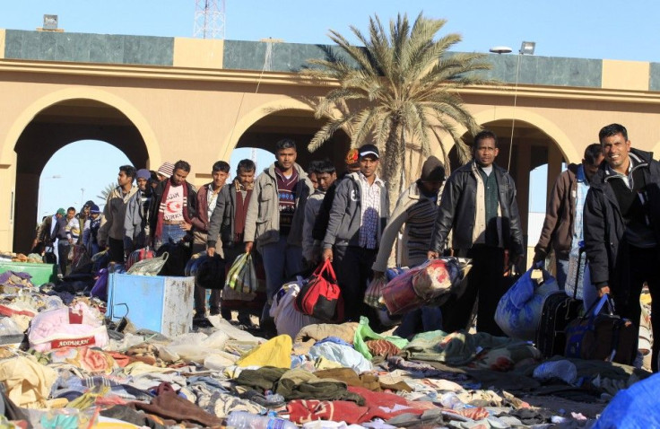 Migrant workers who fled the unrest in Libya line up at Libyan side of the Libyan and Tunisian border crossing of Ras Jdir