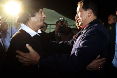 Libya's leader Muammar Gaddafi (L) greets Venezuela's President Hugo Chavez after their meeting in Tripoli October 22, 2010.