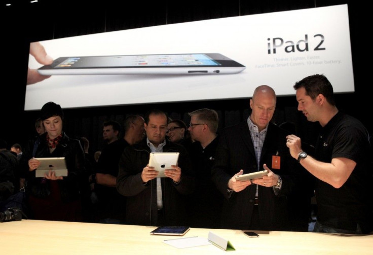 Members of the media look over the Apple iPad 2 during its launch event in San Francisco