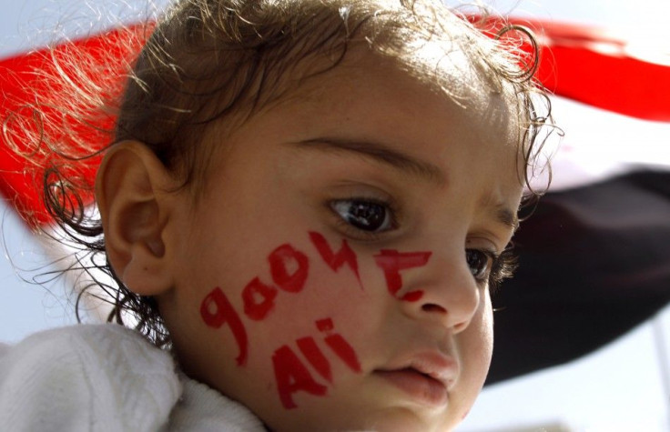 Girl watches during an anti-government protest demanding the ouster of Yemen's President Ali Abdullah Saleh outside Sanaa University