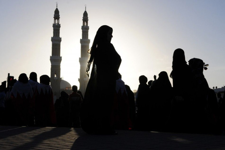 Protesters pass through an old neighbourhood during a demonstration held at the Interior Ministry in Manama