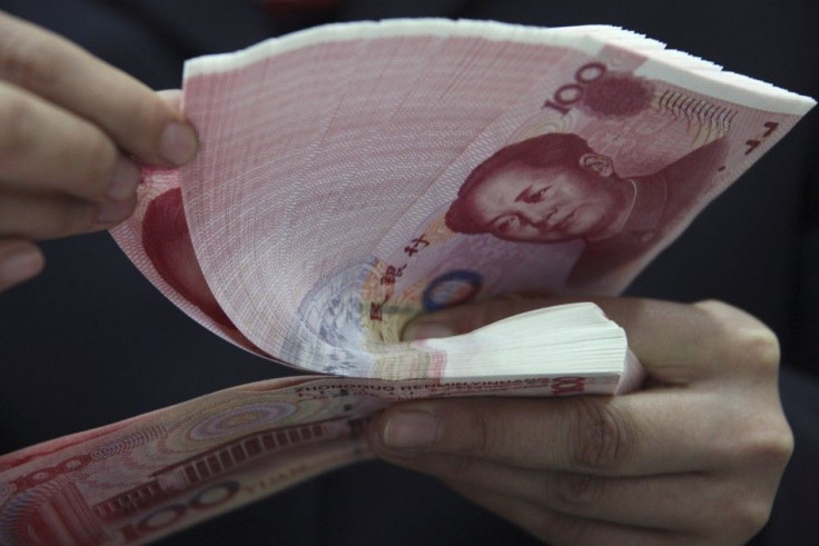 An employee counts yuan banknotes at a branch of Industrial and Commercial Bank of China (ICBC) in Huaibei, Anhui province