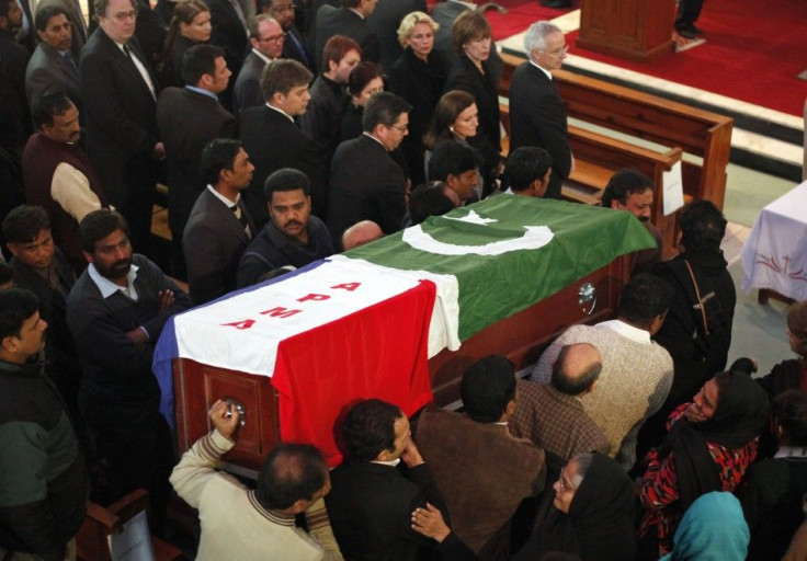 Men carry the casket, wrapped in national and party flags, of Pakistan's Minister for Minorities Shahbaz Bhatt during a funeral ceremony in Islamabad