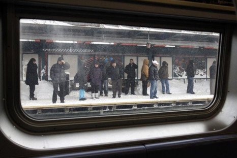 Passengers wait on a subway platform for a train in the Brooklyn section of New York