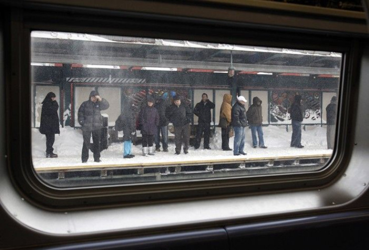 Passengers wait on a subway platform for a train in the Brooklyn section of New York