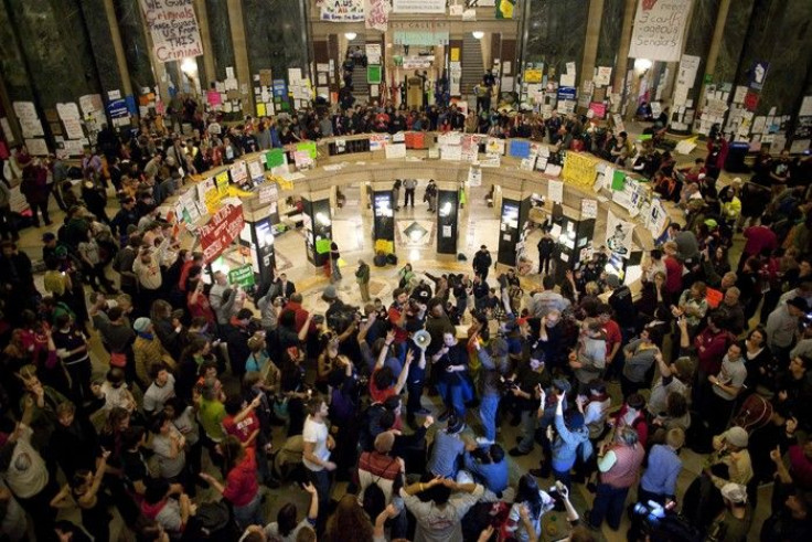 Demonstrators occupy the state Capitol in protest against proposed budget cuts in Madison