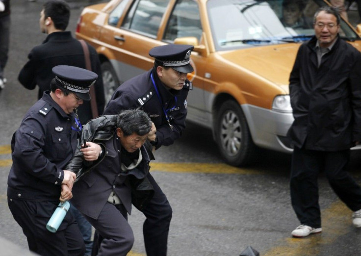 Police arrest a man in front of the Peace Cinema in downtown Shanghai, after calls for a &quot;Jasmine Revolution&quot; protest