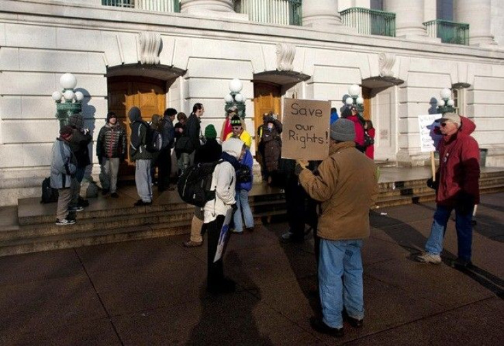 Protestors wait for the doors to open as they continue to occupy the state Capitol to protest against proposed budget cuts, at the state Capitol in Madison, Wisconsin, February 28, 2011.