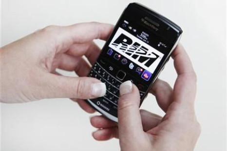 A person poses while using a Blackberry Bold 2 smartphone made by Research in Motion