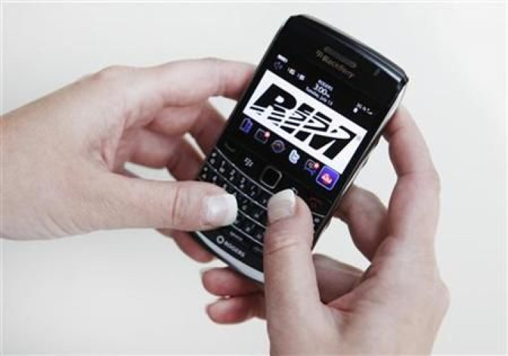 A person poses while using a Blackberry Bold 2 smartphone made by Research in Motion