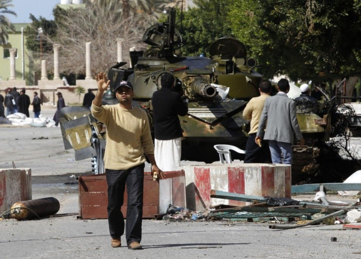 Rebels gather near a tank used by Libyan army defectors in the centre of the city of Zawiyah