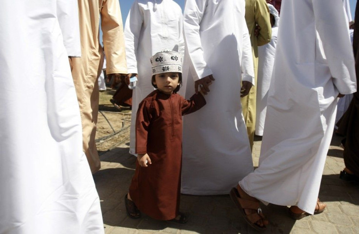 A young boy looks on ahead of Friday prayers in the northern industrial town of Sohar