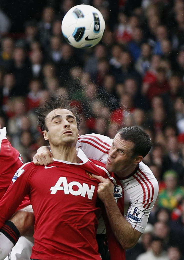 Manchester United's Berbatov challenges Liverpool's Carragher during their English Premier League soccer match at Old Trafford in Manchester.