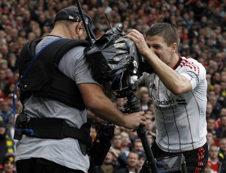 Liverpool's Gerrard celebrates with a television camera after scoring his second goal during their English Premier League soccer match against Manchester United at Old Trafford in Manchester.
