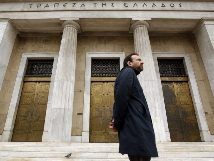A man walks past Bank of Greece in central Athens 