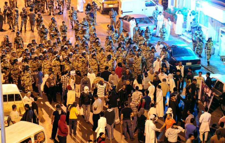 Anti-riot police stand-off with protesters in the Gulf coast town of Awwamiya March 3, 2011.